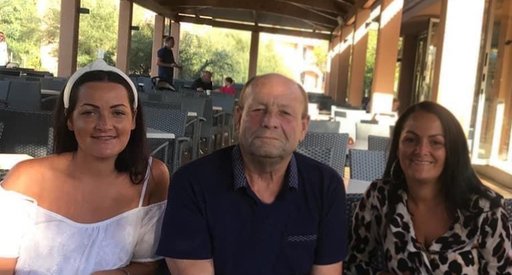 A daughter, father and mother sit together in an empty cafe.