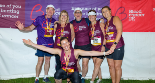 Group of Great North Run supporters posing by Blood Cancer UK banners