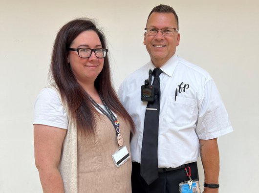Mart and Kayleigh dressed for work with their lanyards on