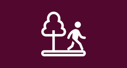 icon of a person walking past a tree