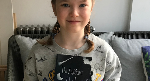A young girl Maddy poses with a book - The Awesome Adventure of Poppy And Amelia.