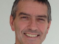 A headshot of Professor Pettitt, a smiling man in his 50s.