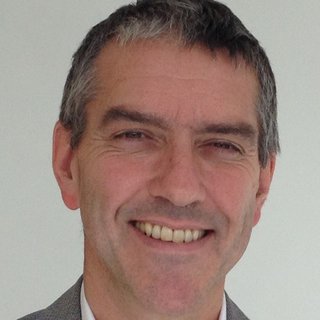 A headshot of Professor Pettitt, a smiling man in his 50s.
