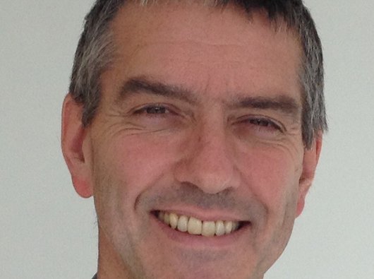 A headshot of Professor Pettitt, a smiling man in his 50s.
