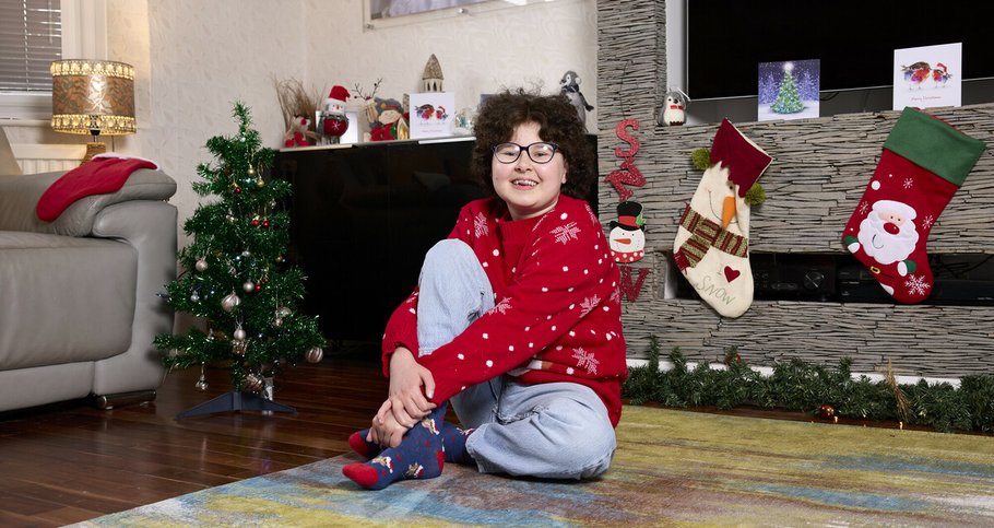 Alyssa, who is in remission from blood cancer, surrounded by Christmas decor at her home.