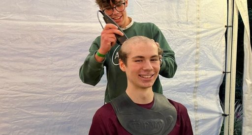 Dominic smiles as he gets his hair shaved after raising over £1000 for Blood Cancer UK