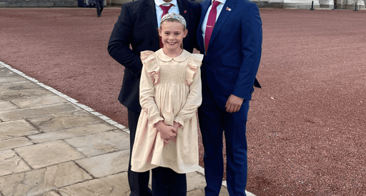 Will Findlay stands outside Buckingham Palace with Tom Youngs and his daughter