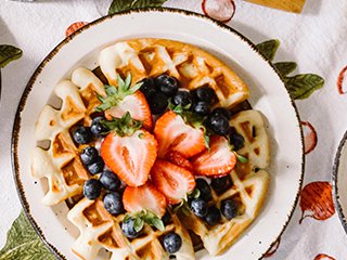 A brunch spread including fruit and waffles