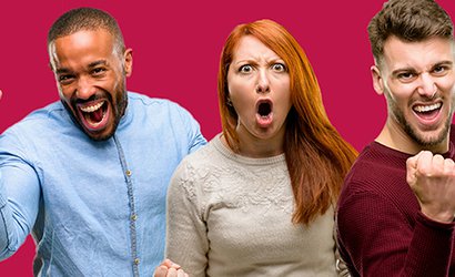 Three people pump their fists in victory